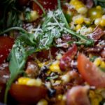 Summer arugula, corn, and tomato salad